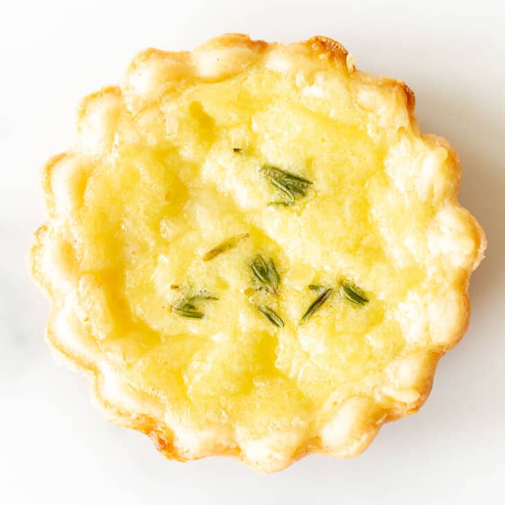 close up of cheese tart with thyme on top