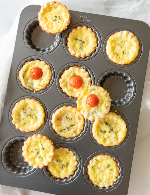 Mini cheese tarts in a baking pan, made with cream cheese pie crust.