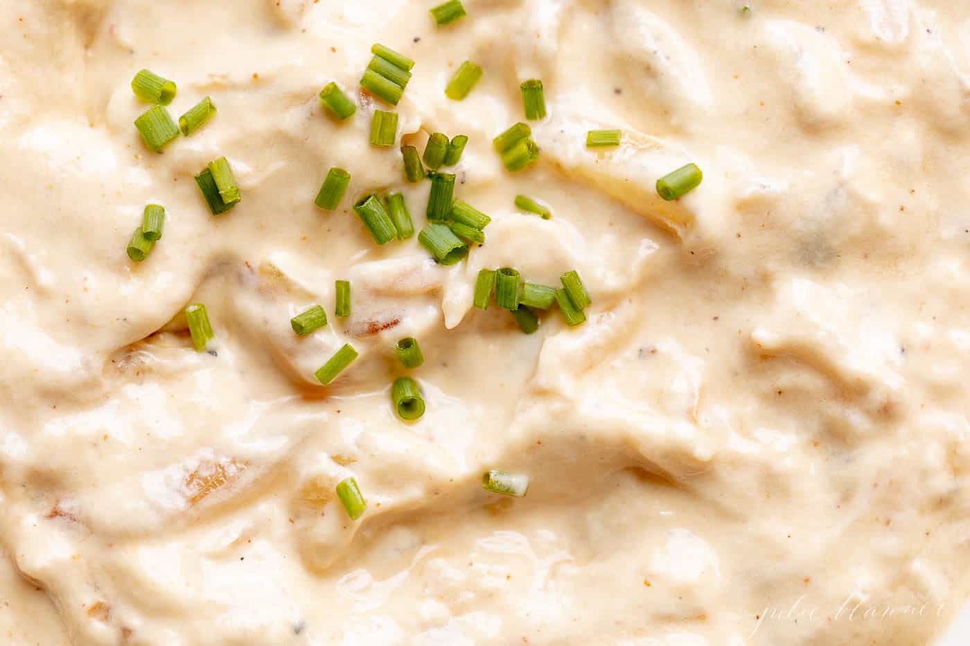 close up of french onion dip garnished with chives