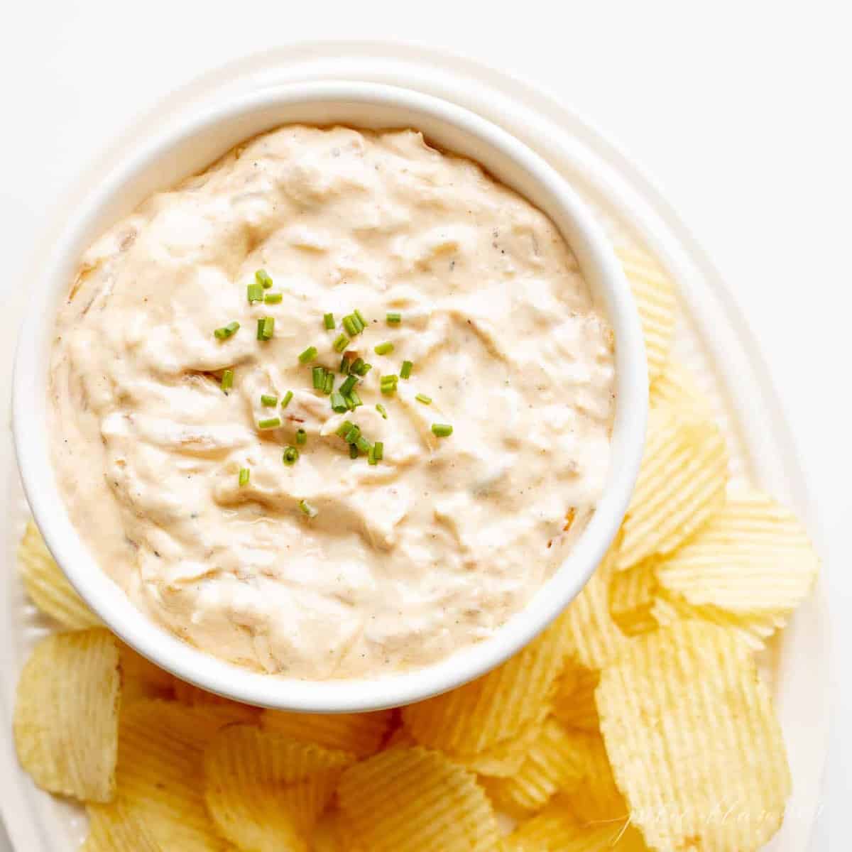 chip and dip platter filled with onion dip and ruffle chips