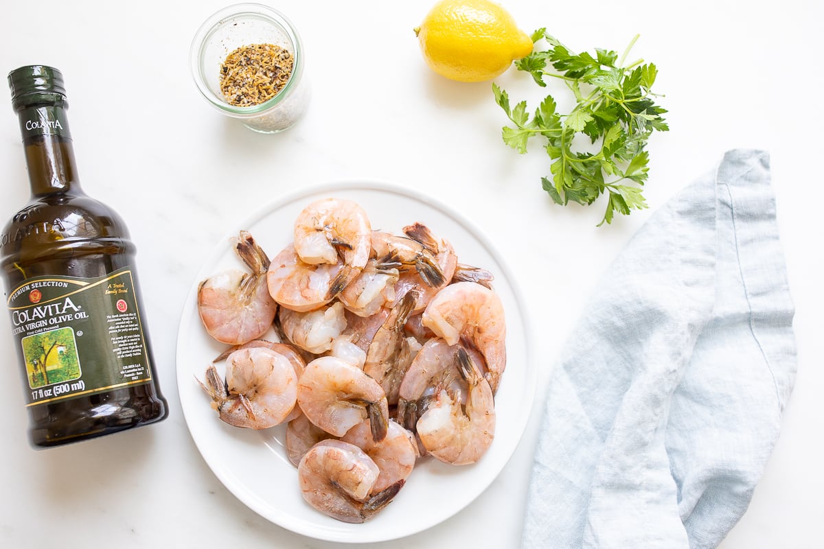 Ingredients for lemon pepper shrimp laid out on a white countertop.