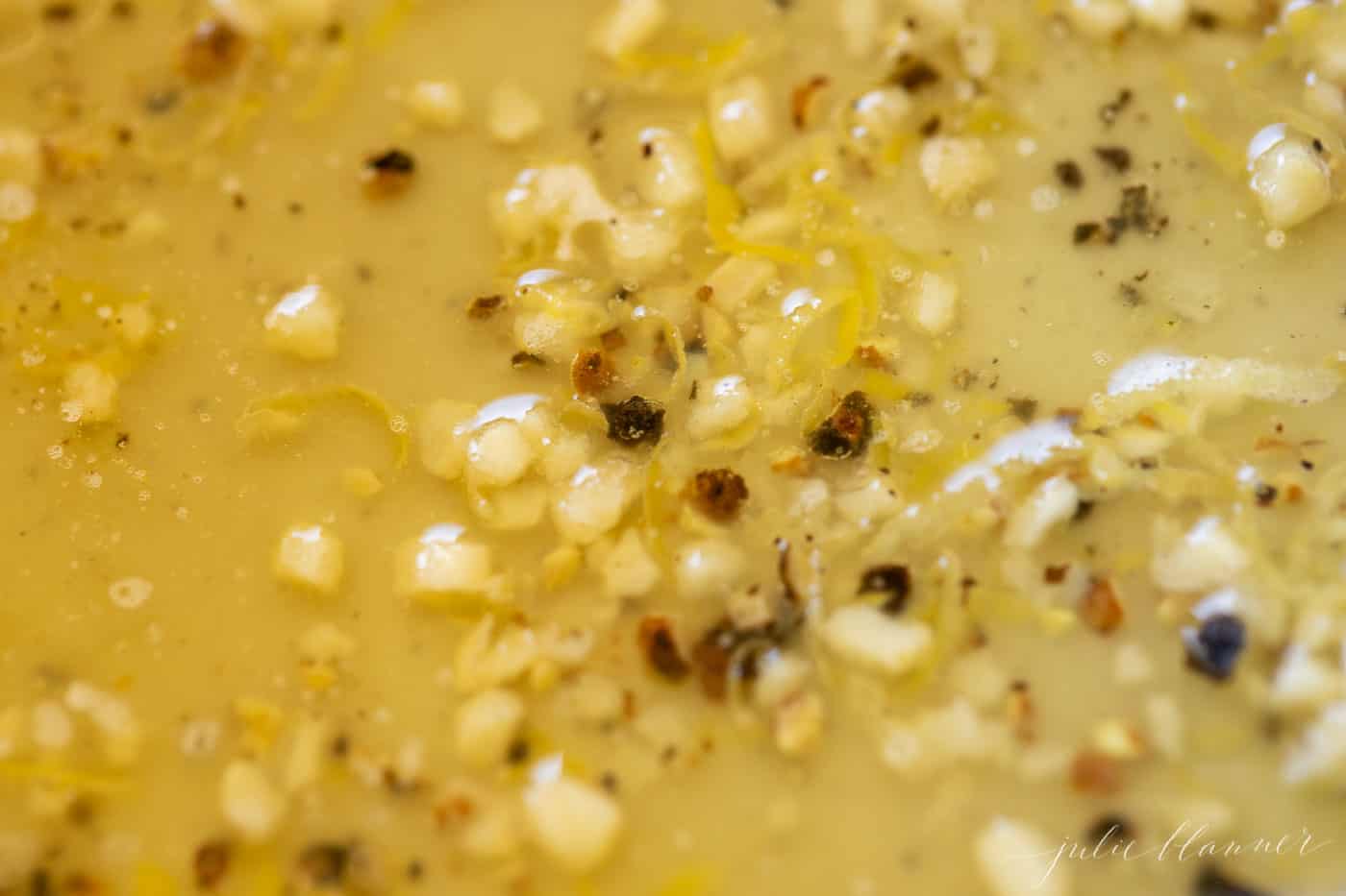 close up shot of lemon pepper sauce in a pan on a stove top