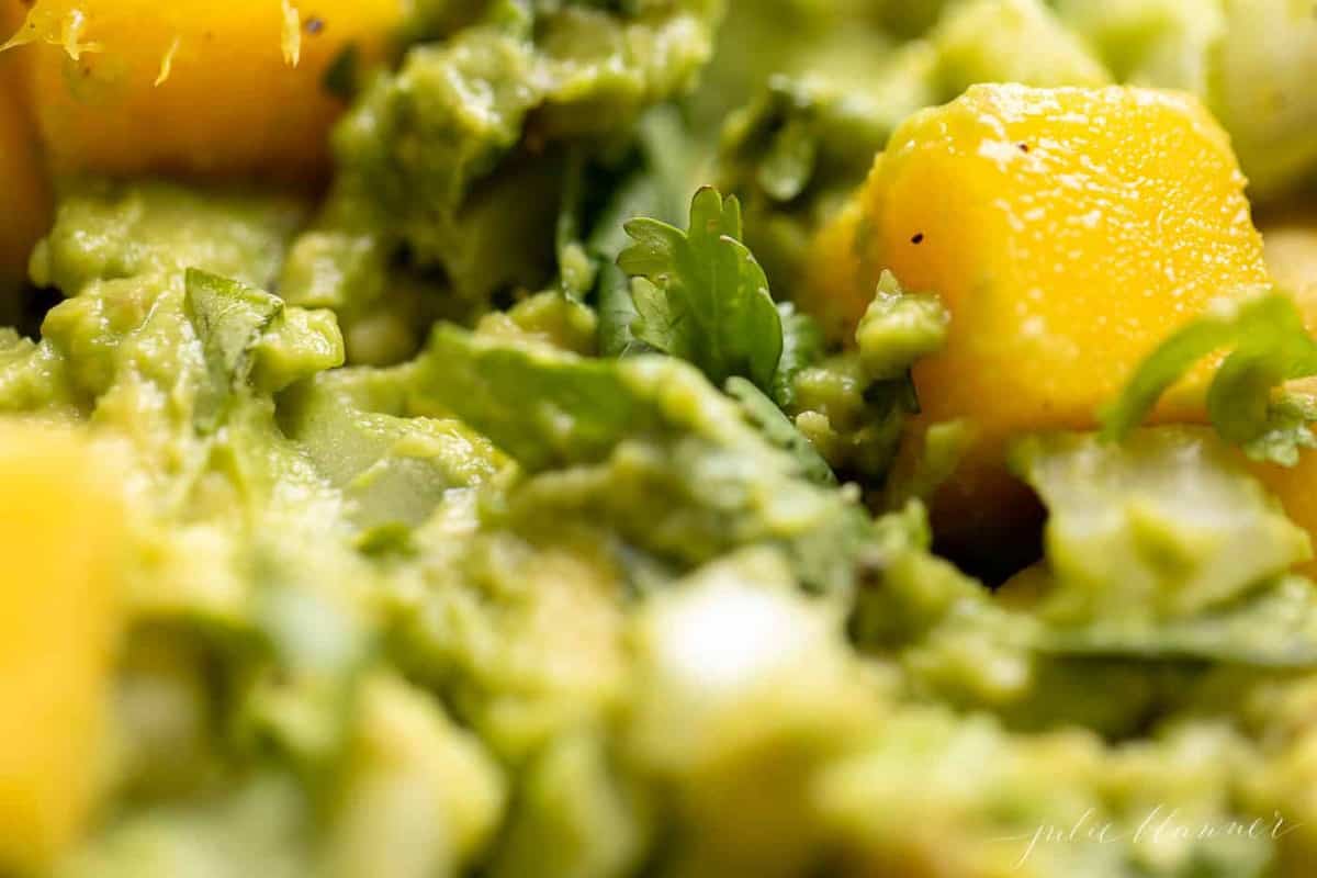 A close up shot of a mango guacamole recipe.