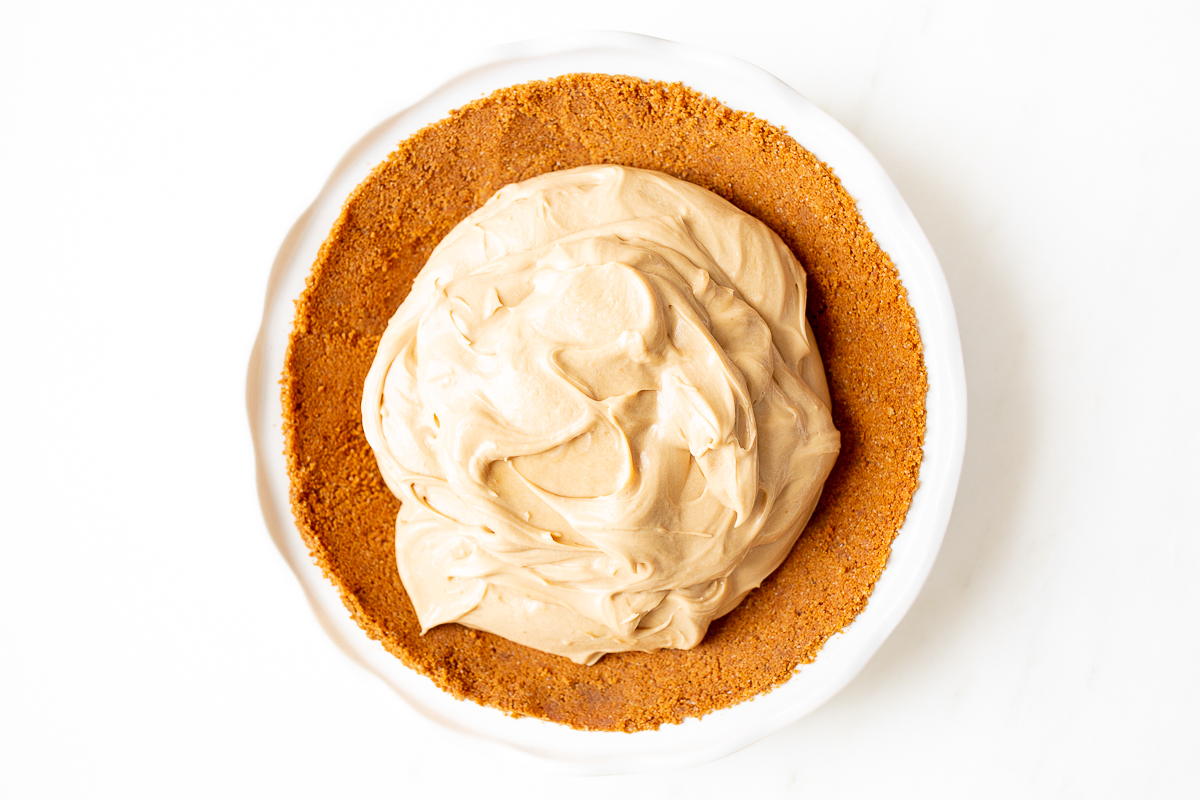 A cookie butter pie on a white countertop.