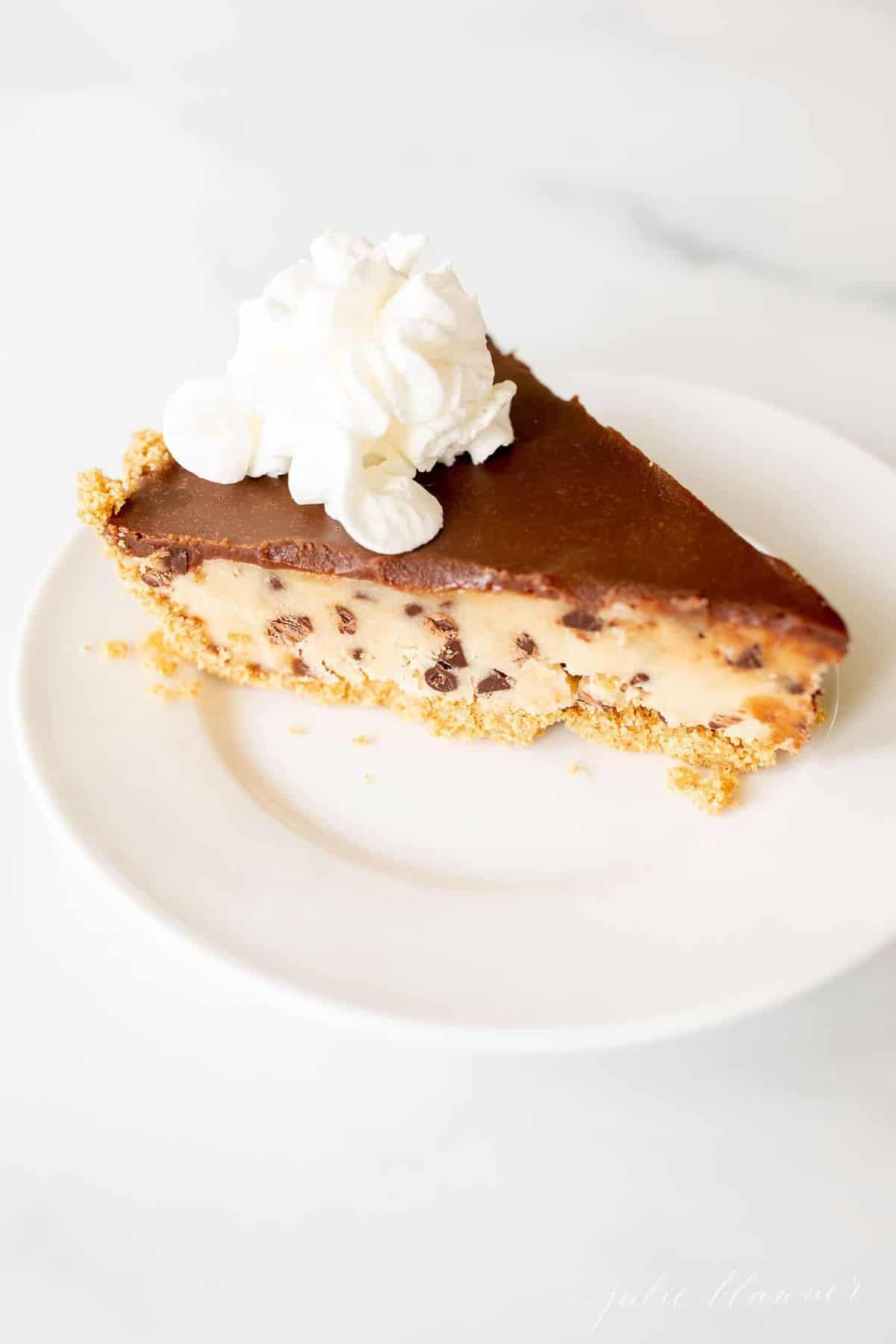 A slice of no bake cookie dough pie on a white plate.