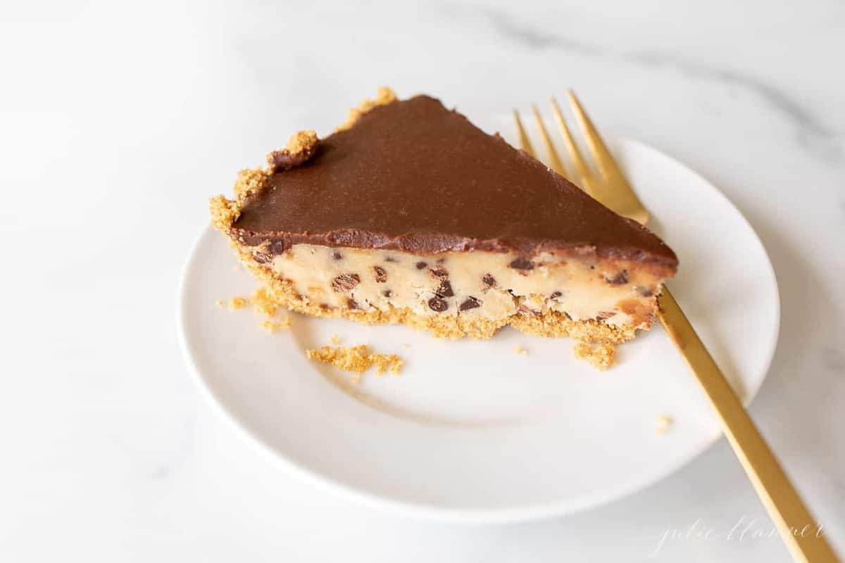 A slice of no bake cookie dough pie on a white plate.