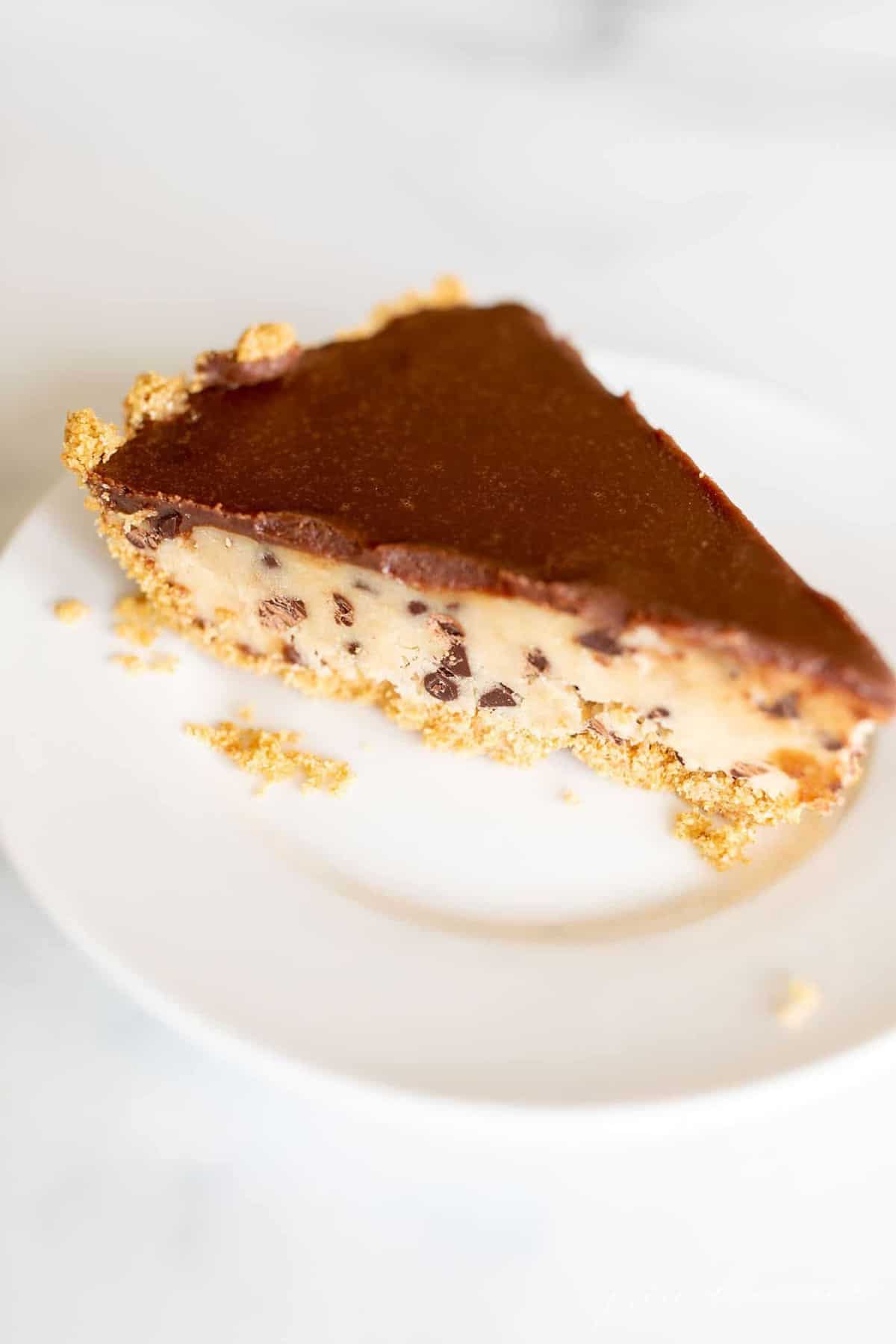 A slice of no bake cookie dough pie on a white plate.