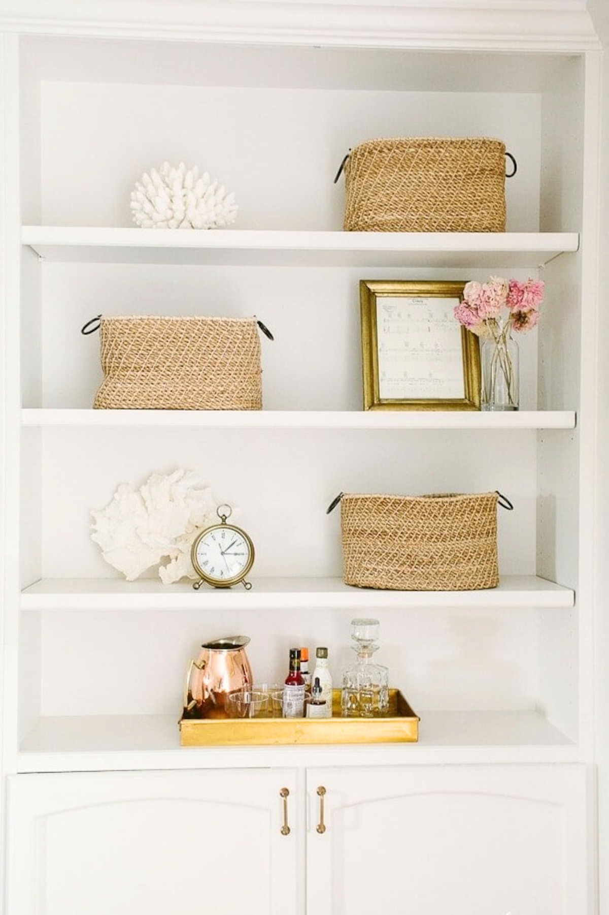 A DIY wall decor idea featuring a white shelf adorned with baskets and flowers.
