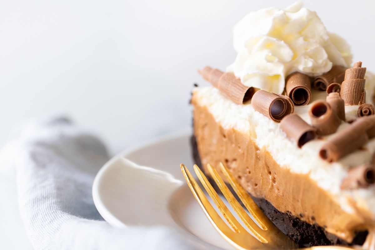 A slice of French silk pie on a white plate.