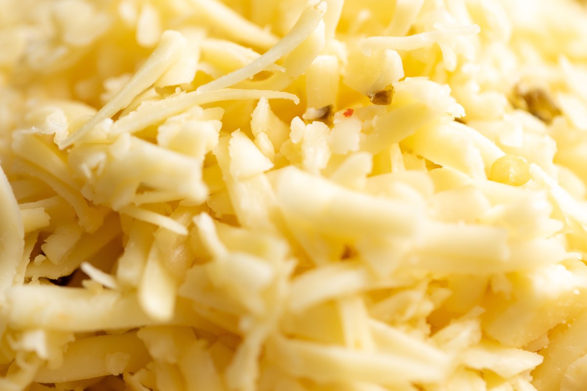 A close up shot of fresh shredded pepperjack cheese