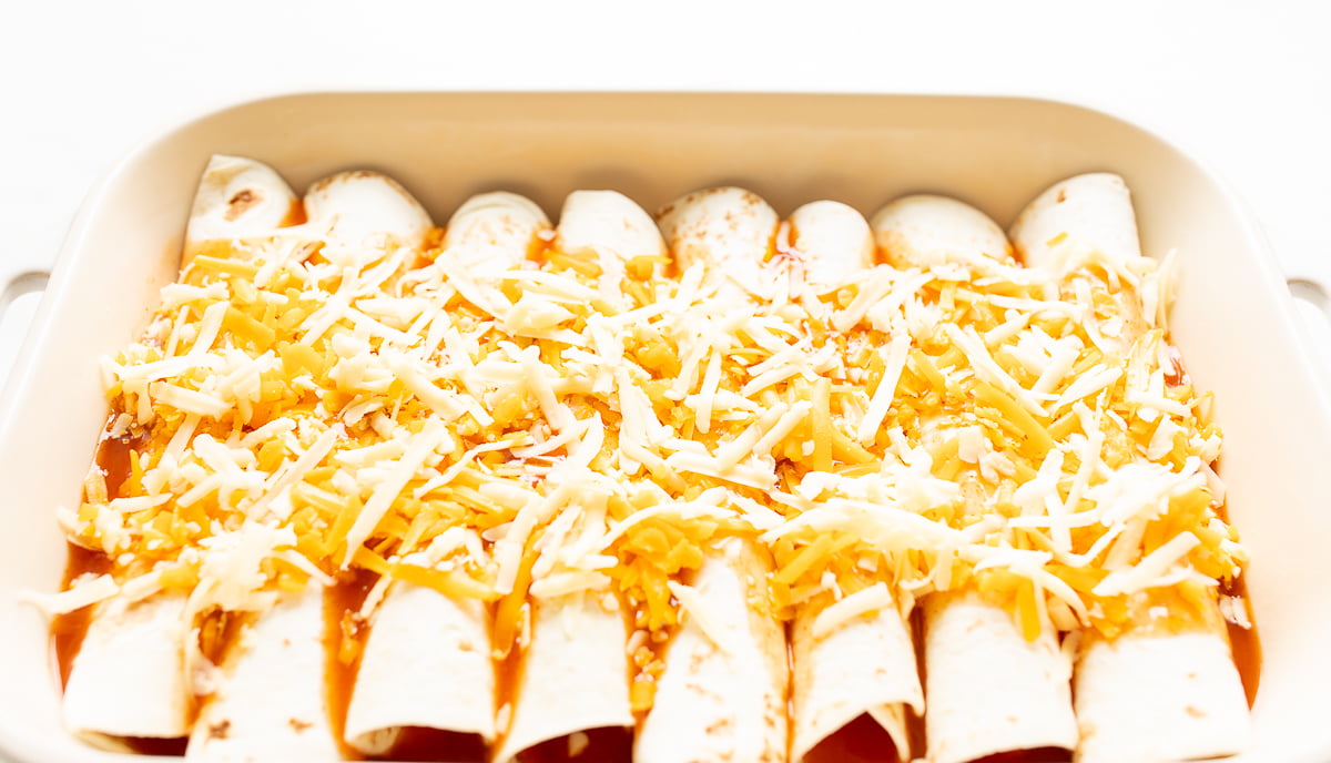 A pan full of a chicken enchilada recipe before it goes into the oven.