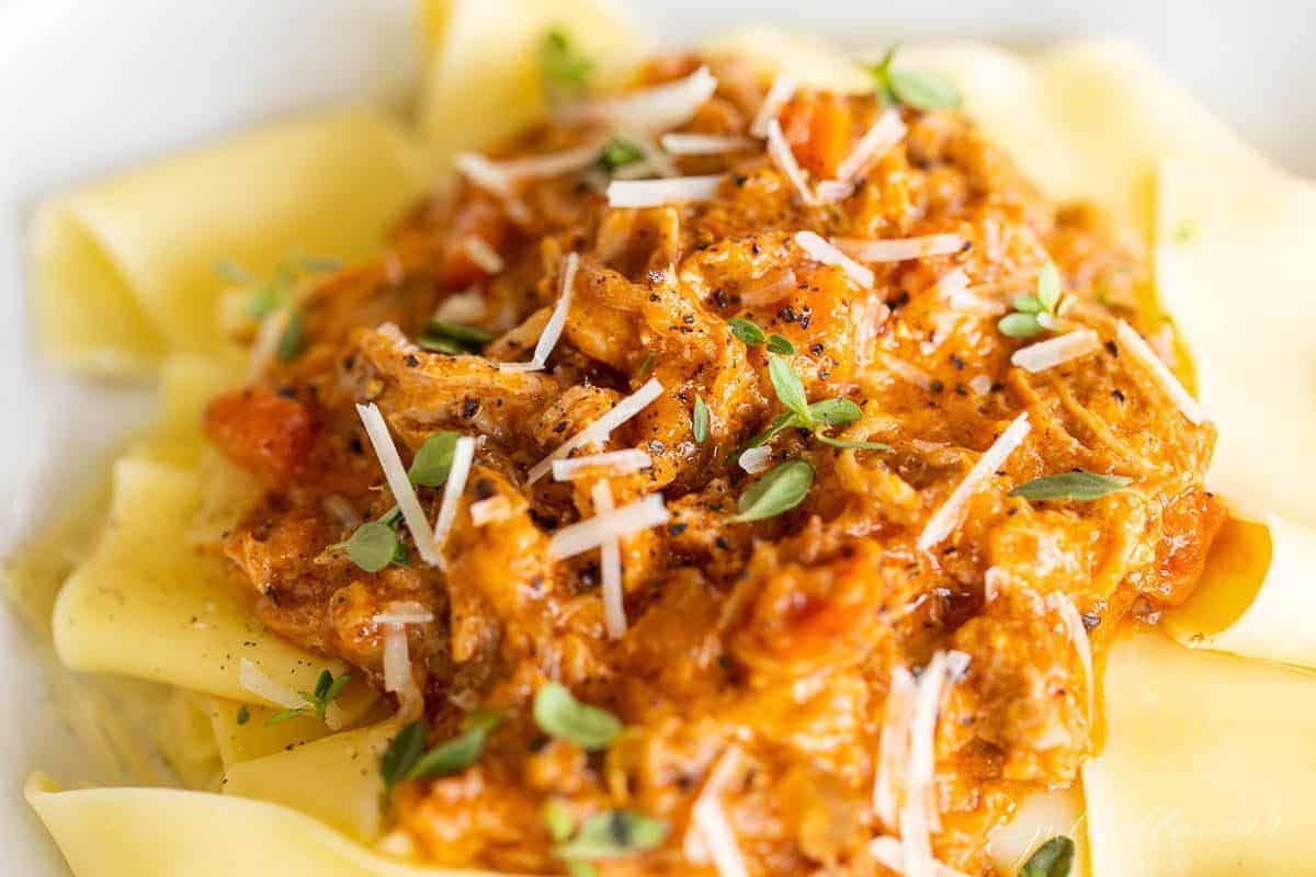 A bowl of papardelle pasta covered in pork ragu