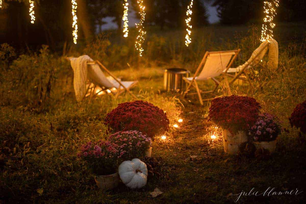 chairs by fire with candlelight mums and pumpkin decor