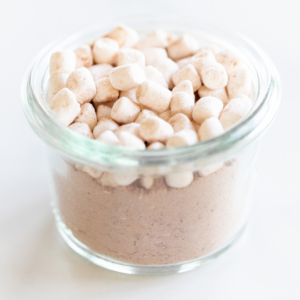 Homemade hot chocolate mix with chocolate marshmallows in a glass jar.