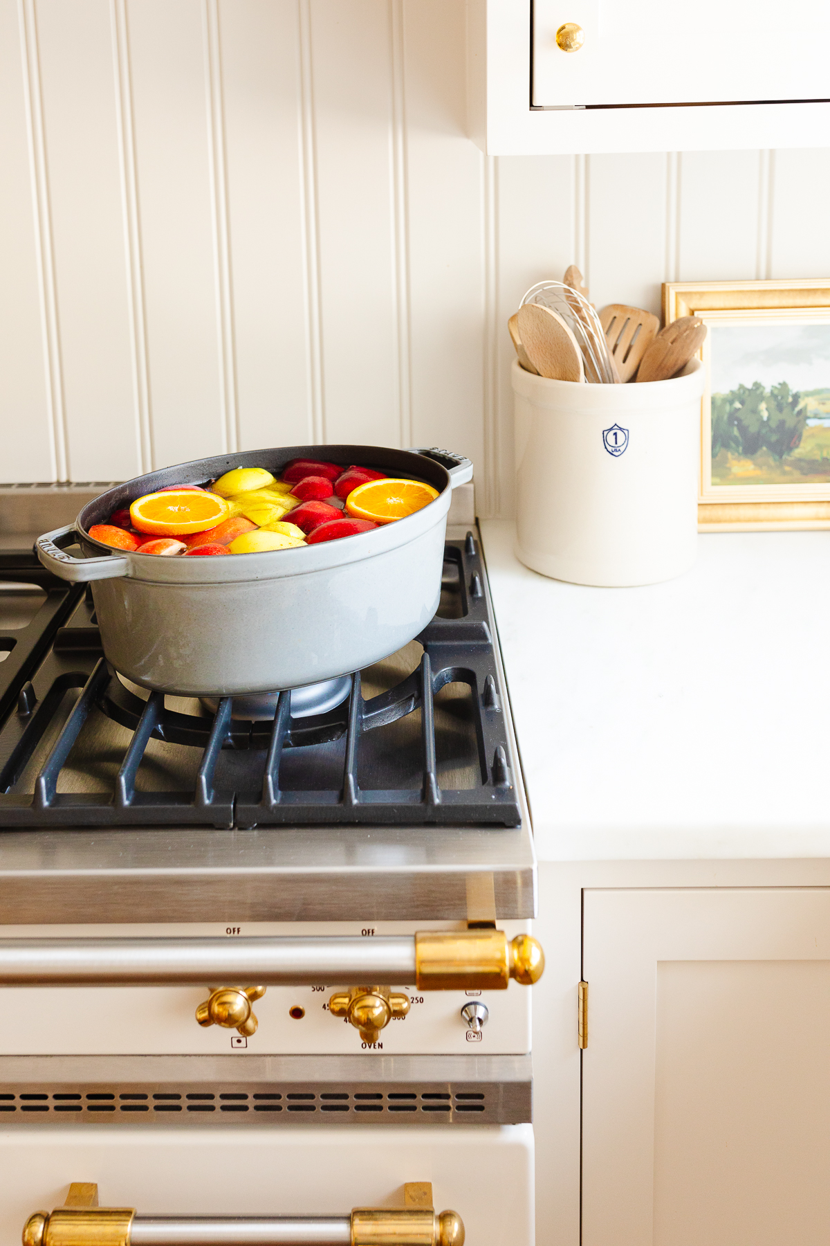 a white kitchen with homemade apple cider in a gray Dutch oven