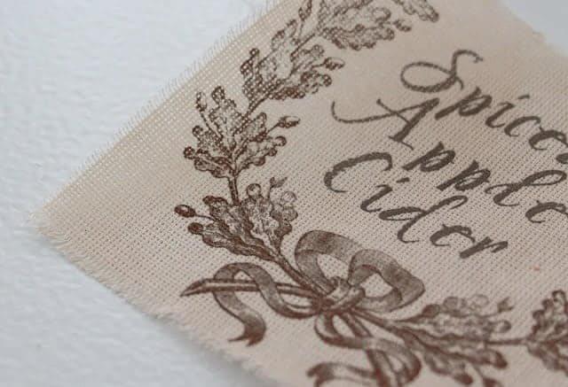 A piece of fabric with a spiced apple cider label printed on it.
