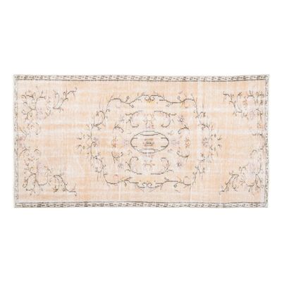 A vintage Turkish rug on a white background.