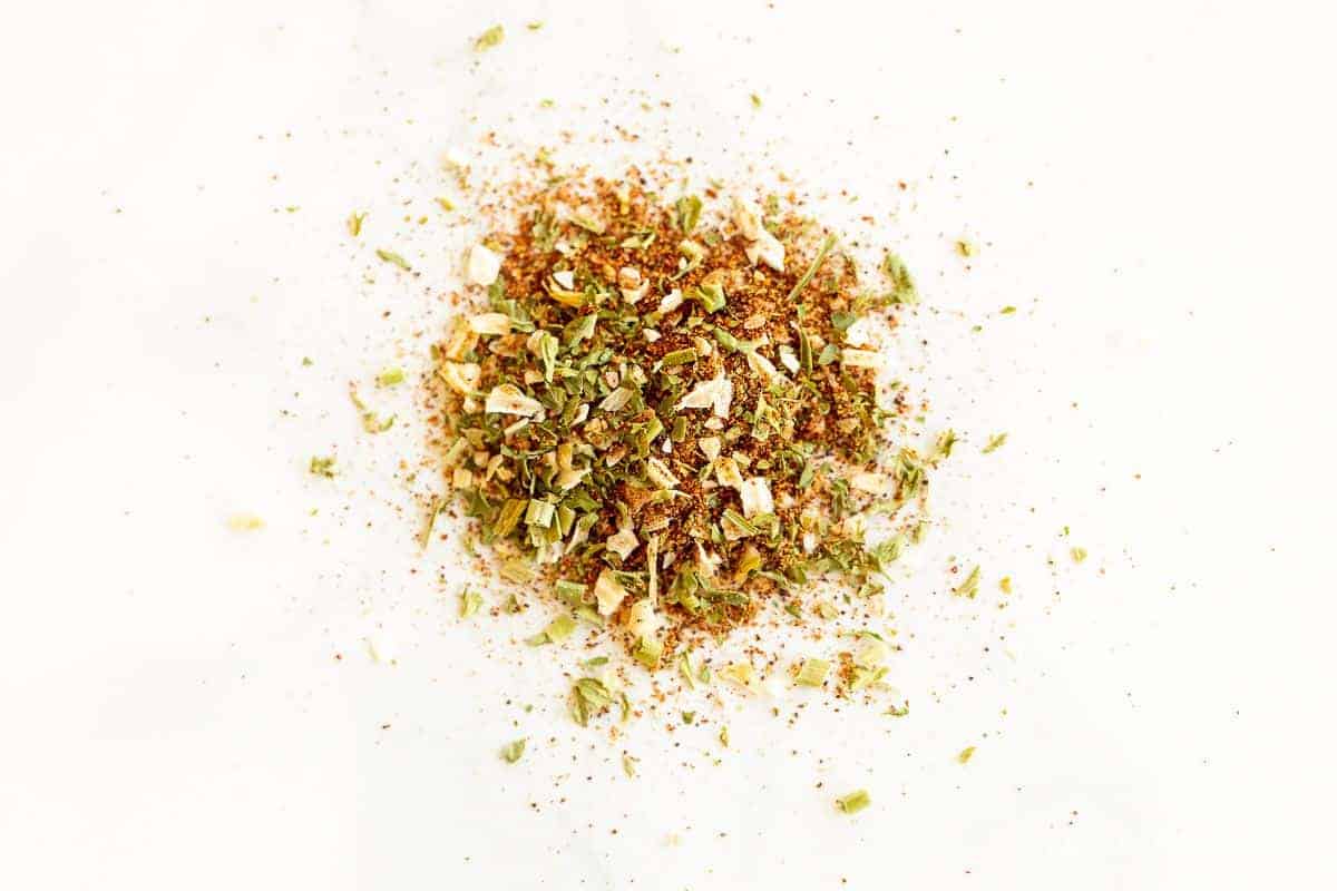 A pile of homemade fiesta ranch seasoning mix on a white surface.
