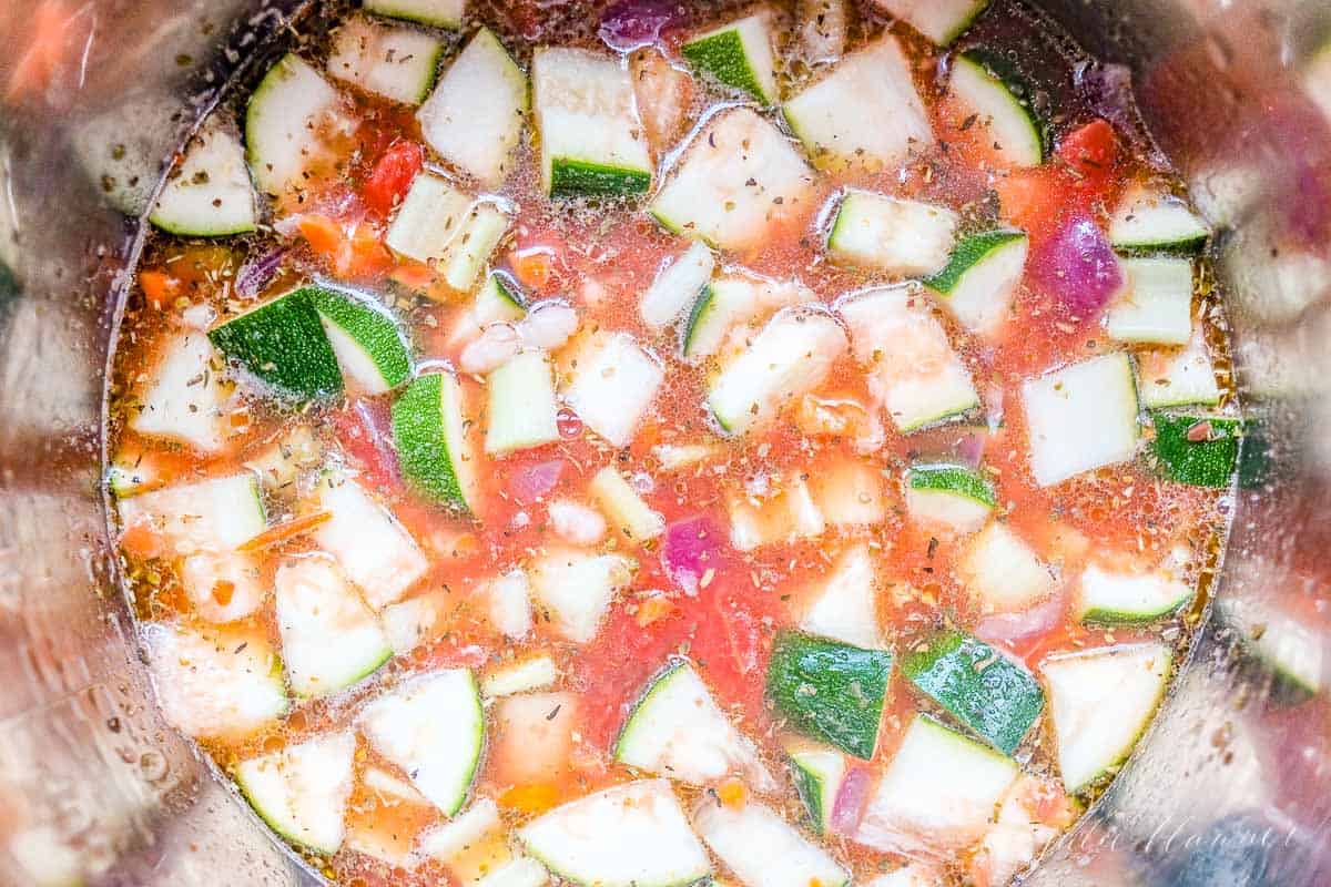 Looking into a pot full of a minestrone soup recipe.