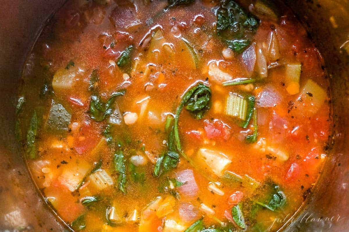 Looking into a pot full of a minestrone soup recipe.