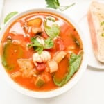 A white bowl of minestrone soup.