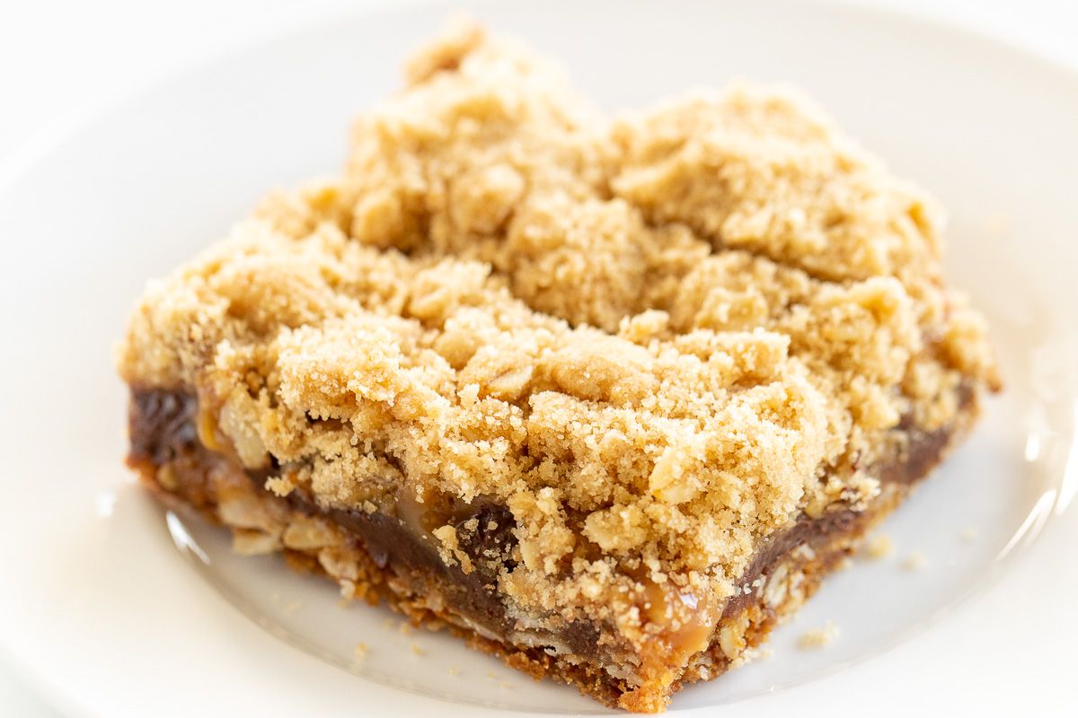 Caramel oatmeal chocolate chip bar on a white plate