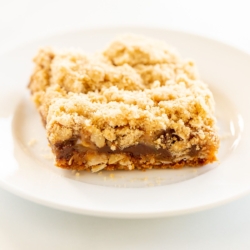 Caramel oatmeal chocolate chip bar on a white plate