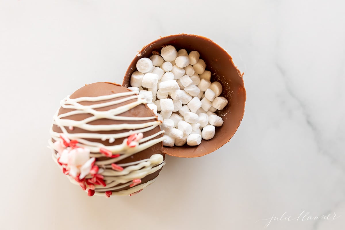         Description: A peppermint hot chocolate bomb, shaped like a chocolate egg filled with marshmallows and candy canes.