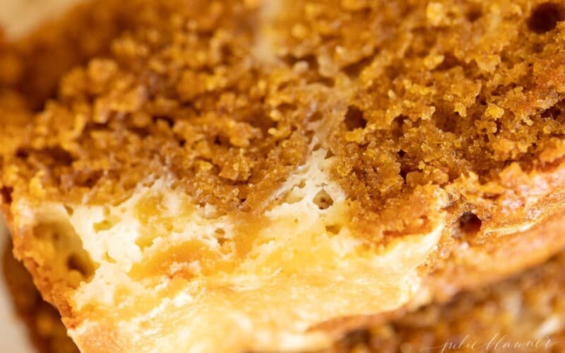 A close up shot of a slice of pumpkin cheesecake bread.