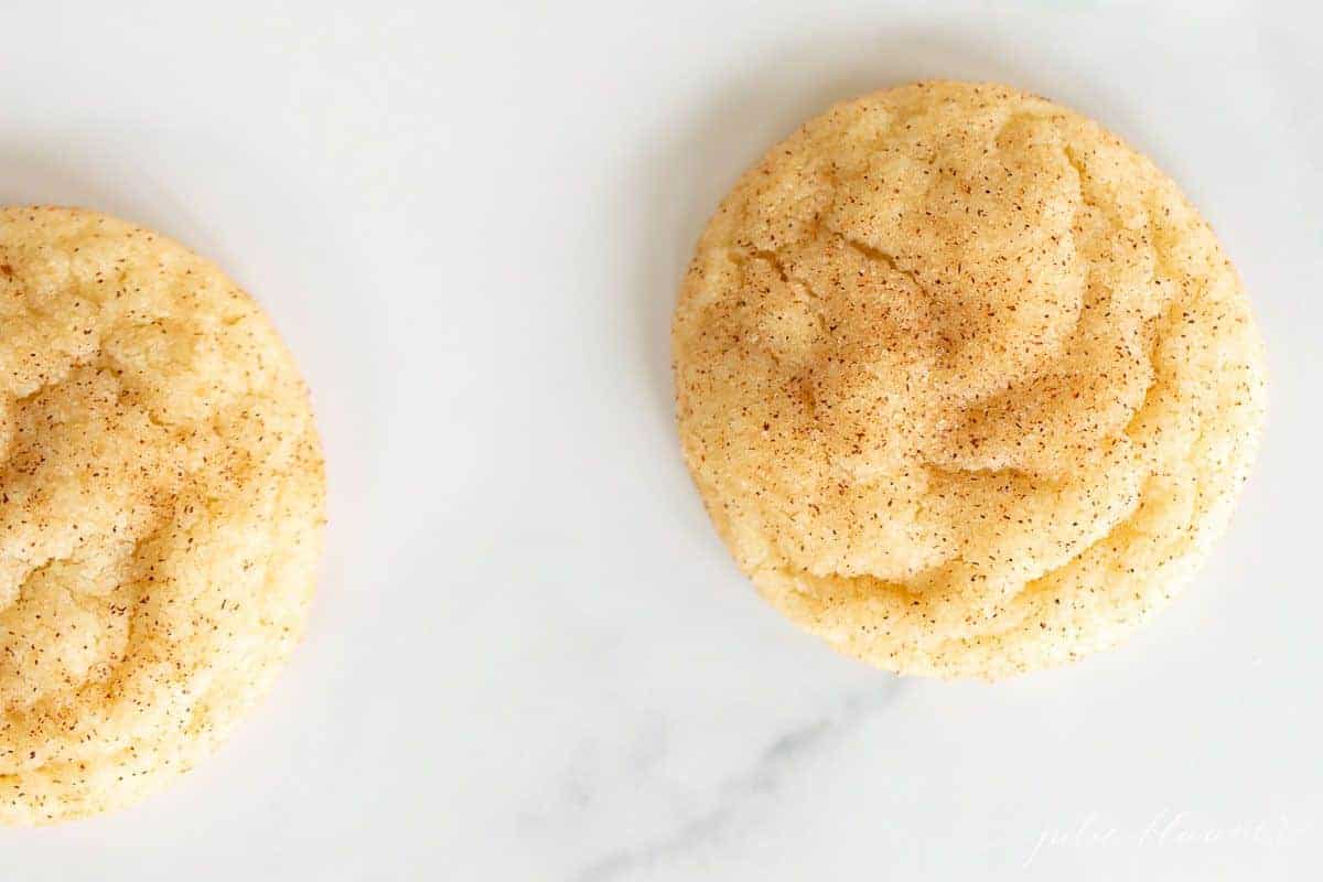 Snickerdoodles without cream of tartar spread out on a marble surface.