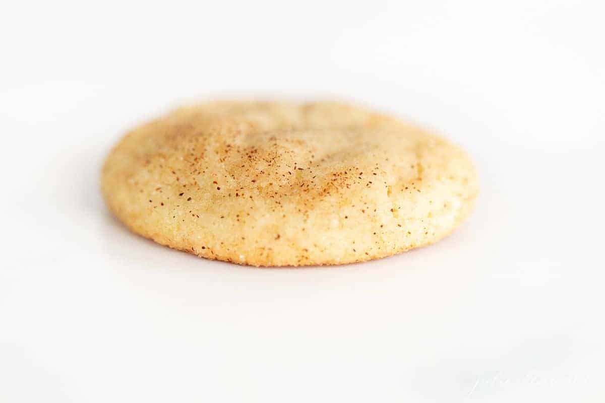 A single snickerdoodle without cream of tartar on a white background.