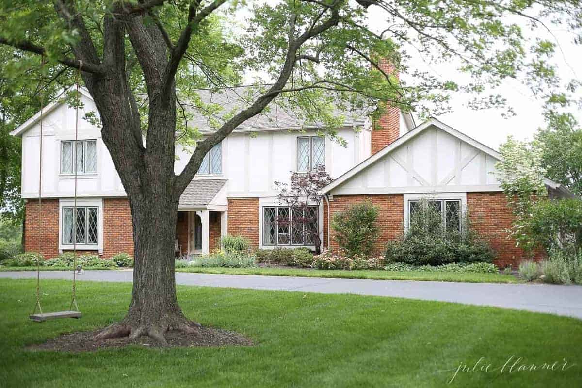 tree swing hanging in front of cream home