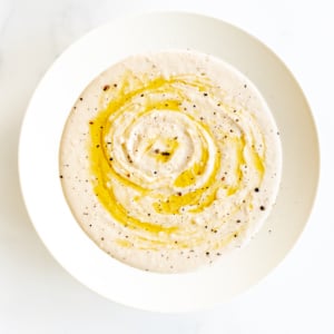A white bowl of cannellini bean dip