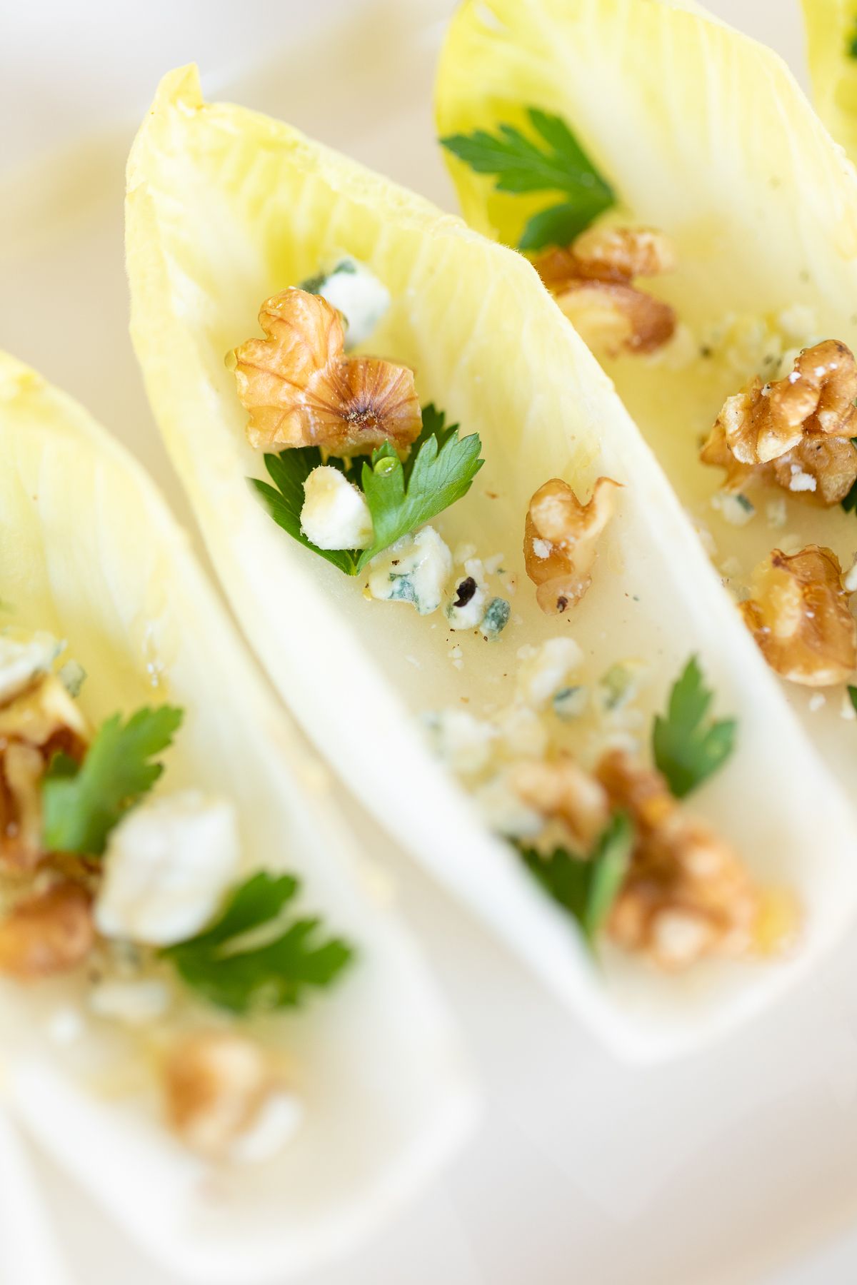 An endive salad laid out on a white platter. 