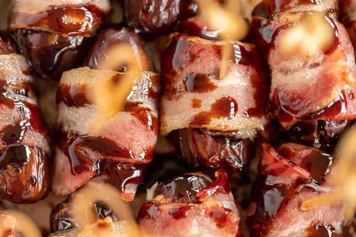 A pan full of baked bacon wrapped dates.