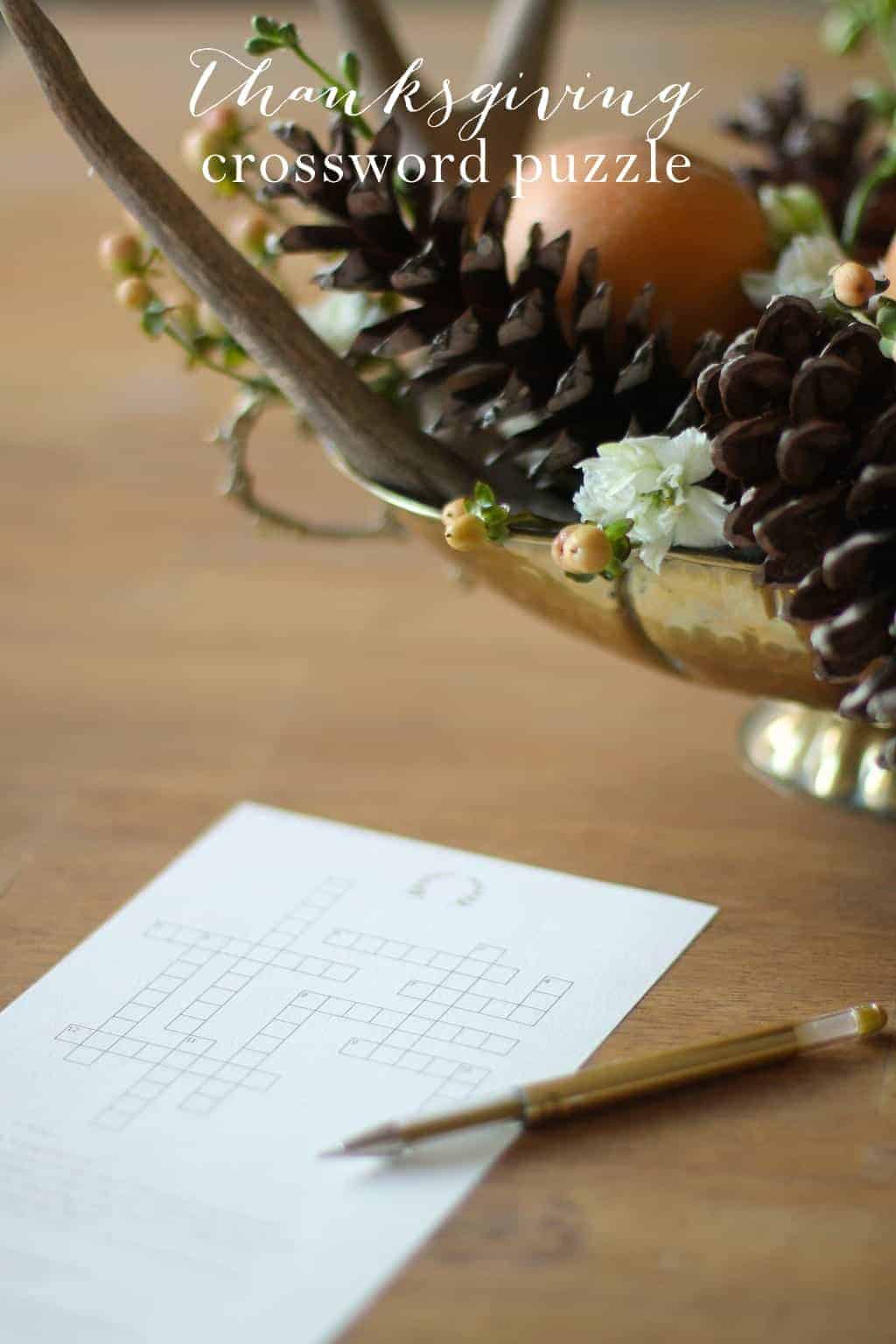 A printable Thanksgiving crossword puzzle on a wooden table with a gold centerpiece in the background.