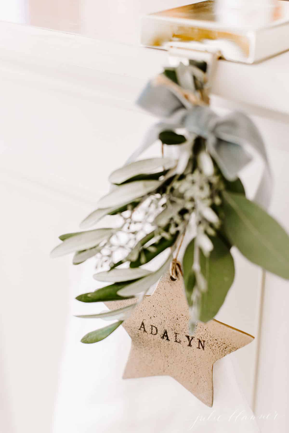 Touches of greenery on a hand stamped gold star for a child's Christmas stocking.