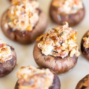 Bacon stuffed mushrooms on a white platter.