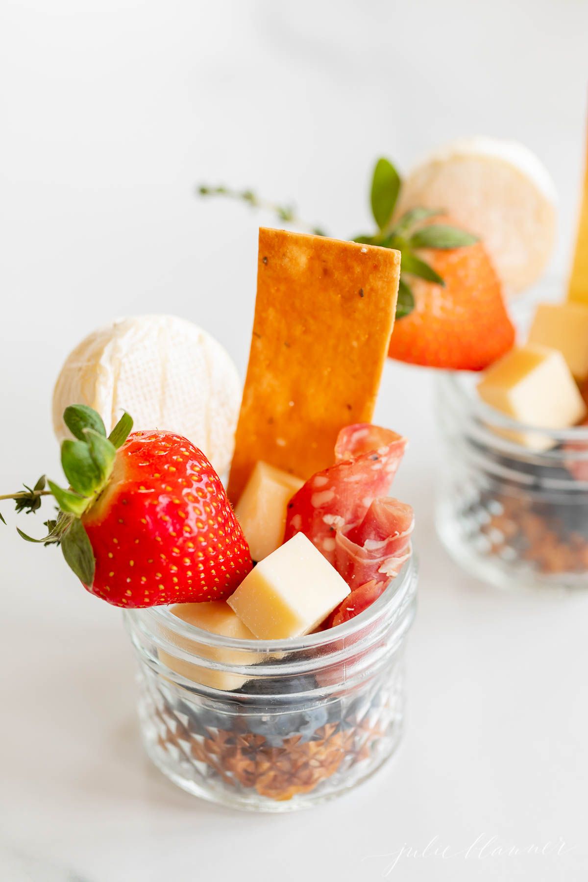 Charcuterie in a jar on a marble countertop