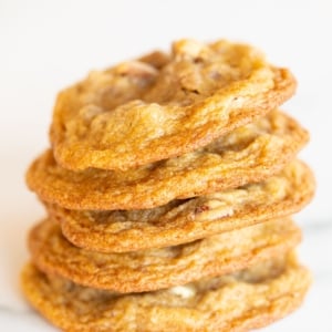 A stack of pecan cookies on a white countertop.