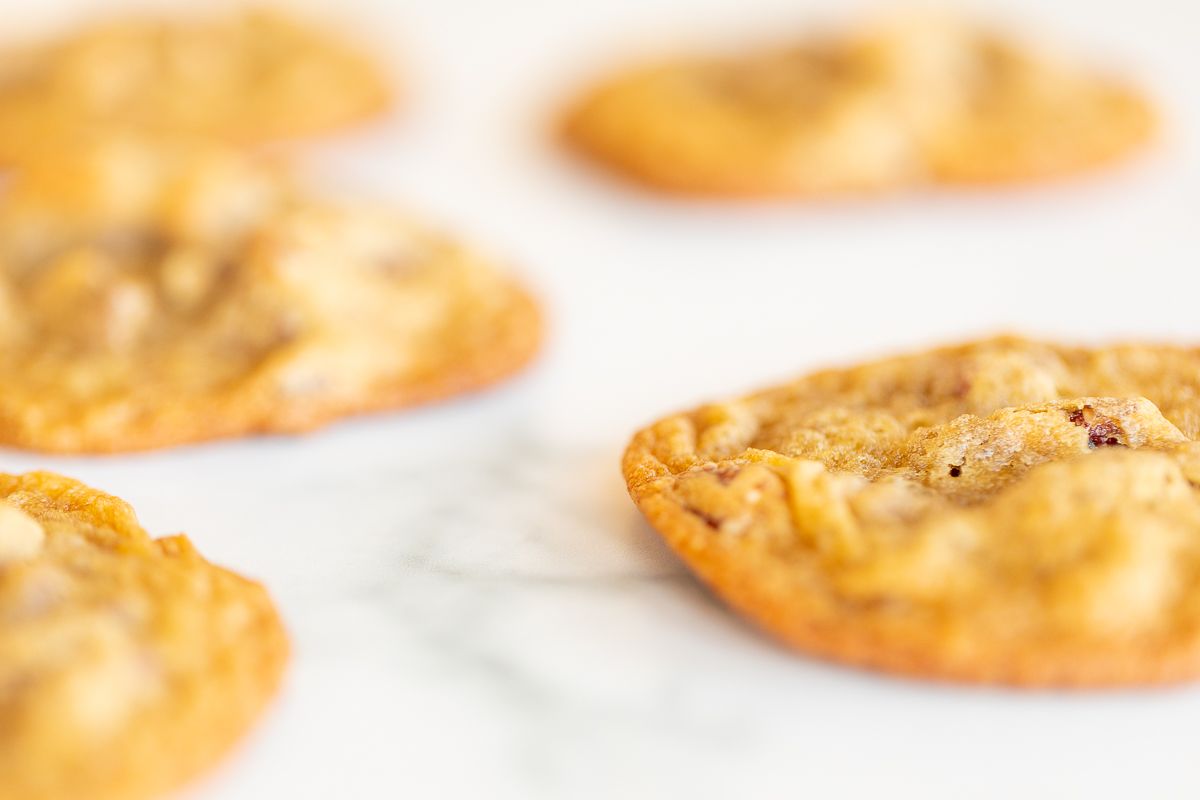 Pecan pie cookies laid out on a white surface.