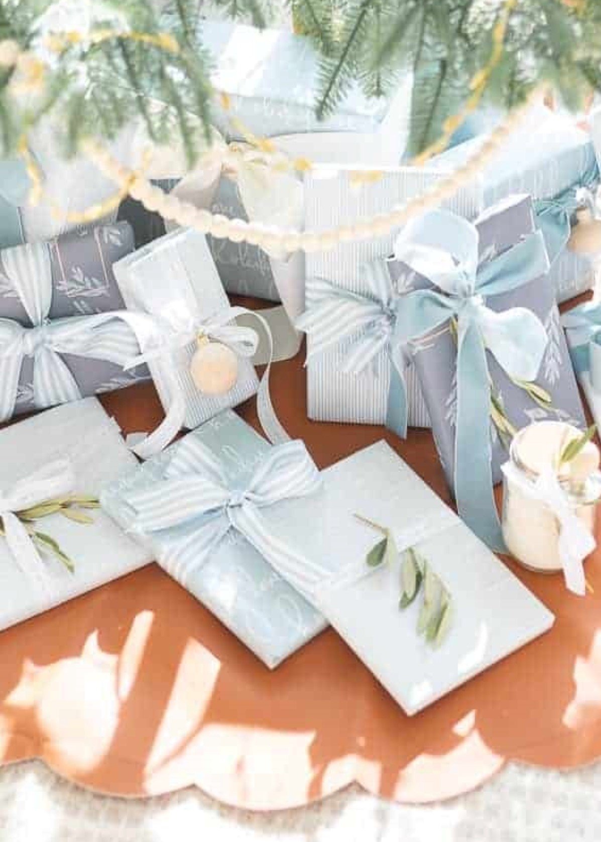 Gift wrapping. Wrapping paper, tape and gift box on a light wooden