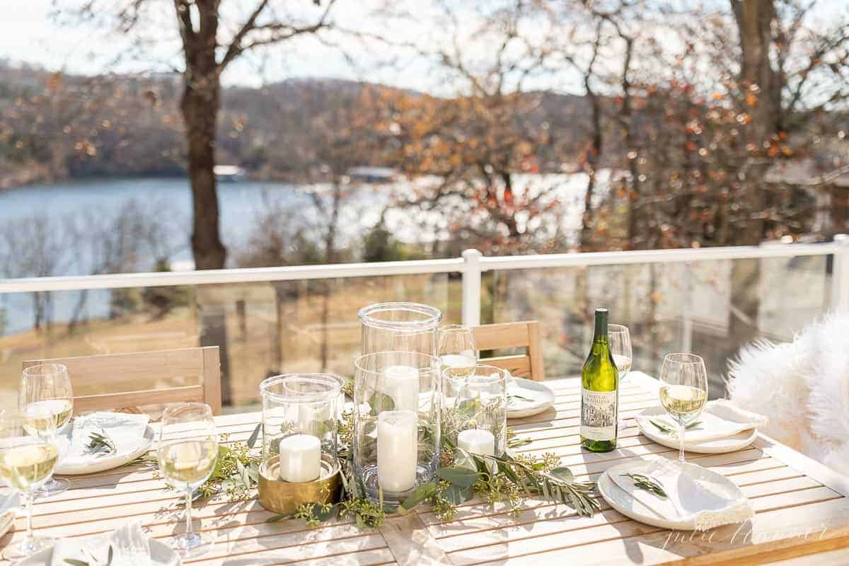 table set in front of glass deck panels exposing lake view