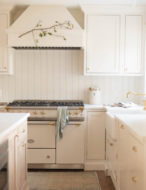 A cream classic kitchen with a french range and inset cabinets.