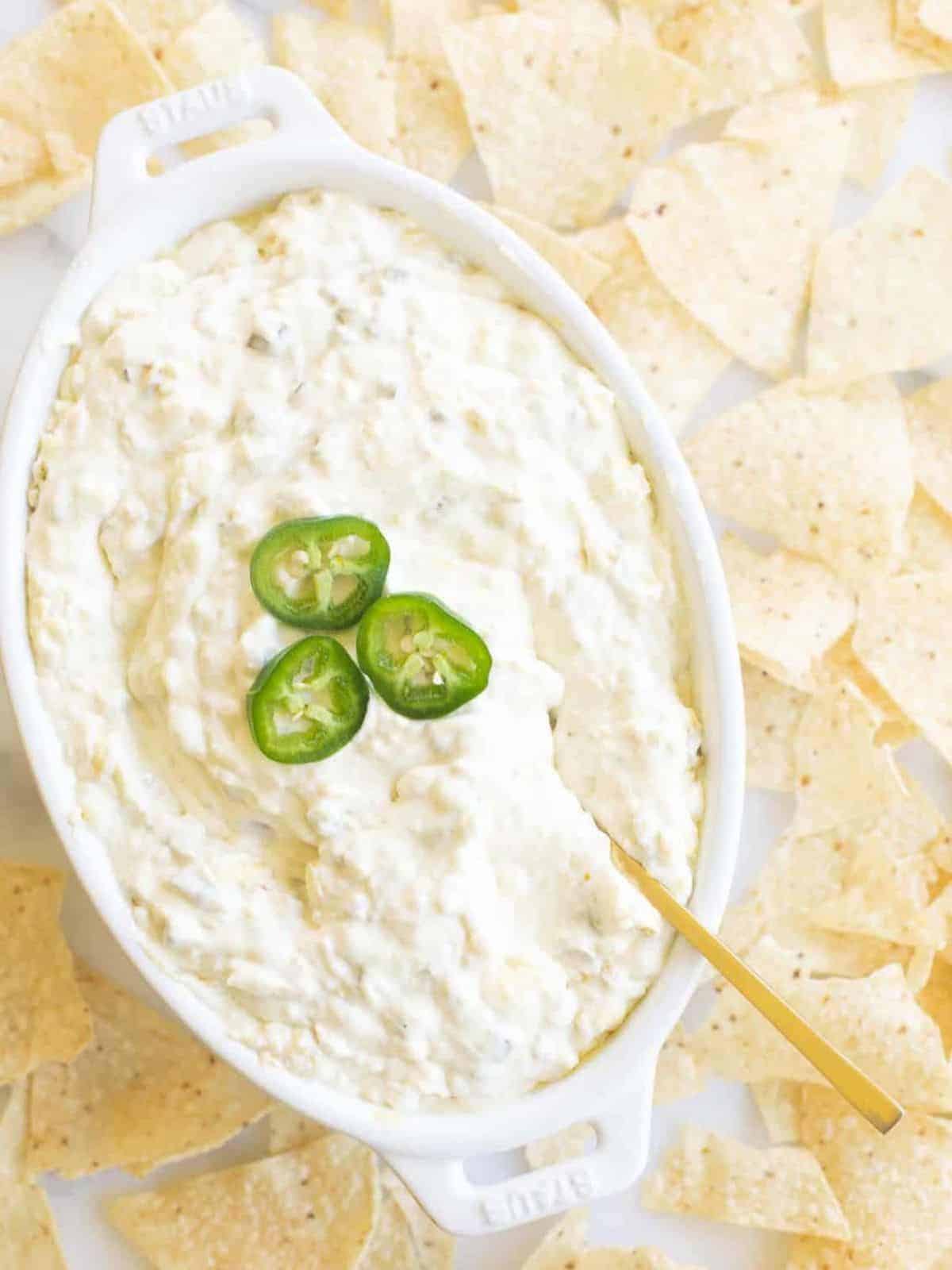 creamy jalapeno dip in dish surrounded by tortilla chips