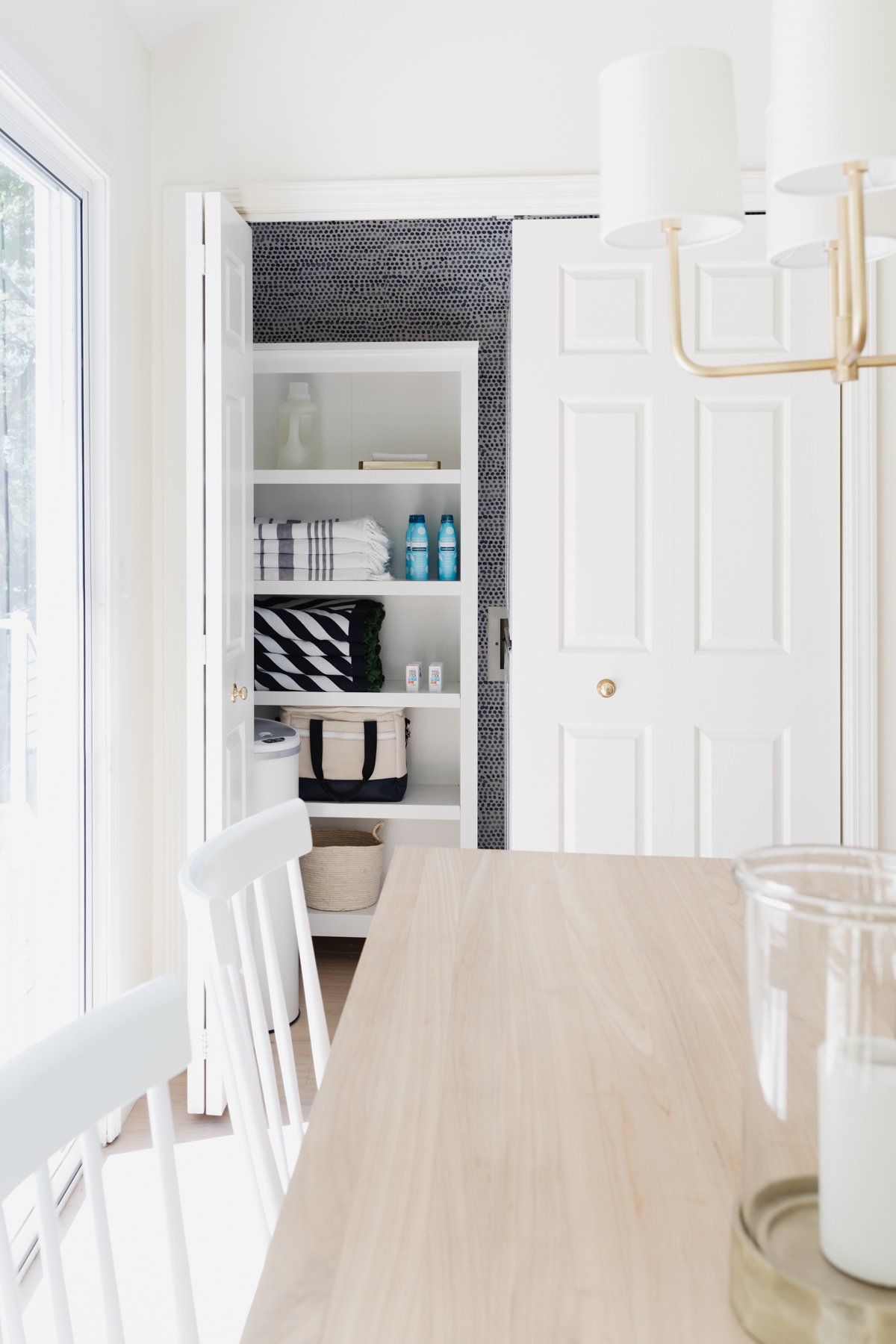 A white kitchen and an organized closet space in a guide to minimalist living