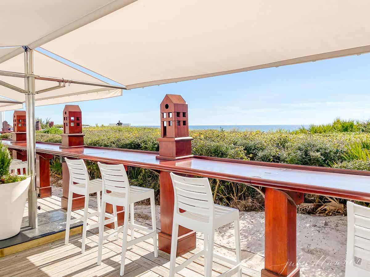 A white restaurant bar area and white awning on a beach in Seaside Florida