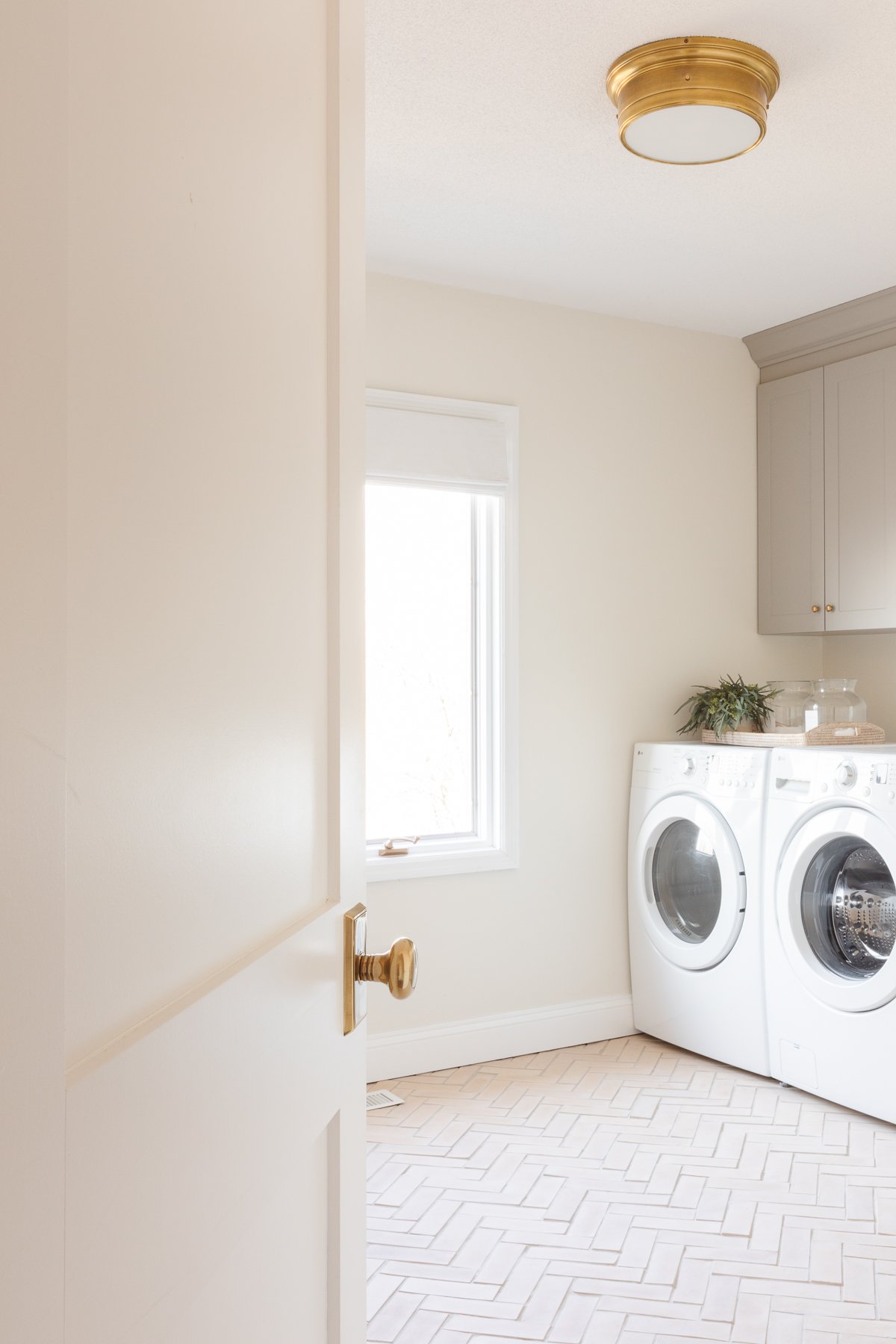 A laundry room with shaker style doors on the washer and dryer units.