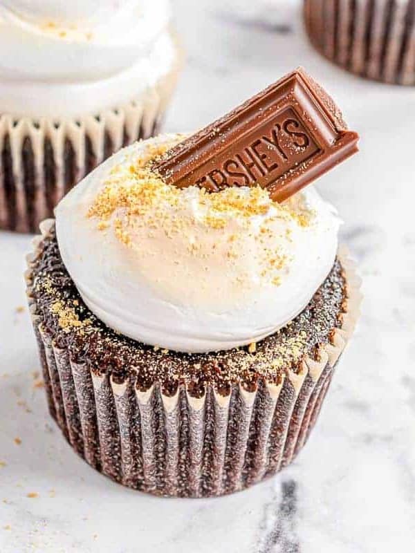 S'mores cupcakes on a marble surface.