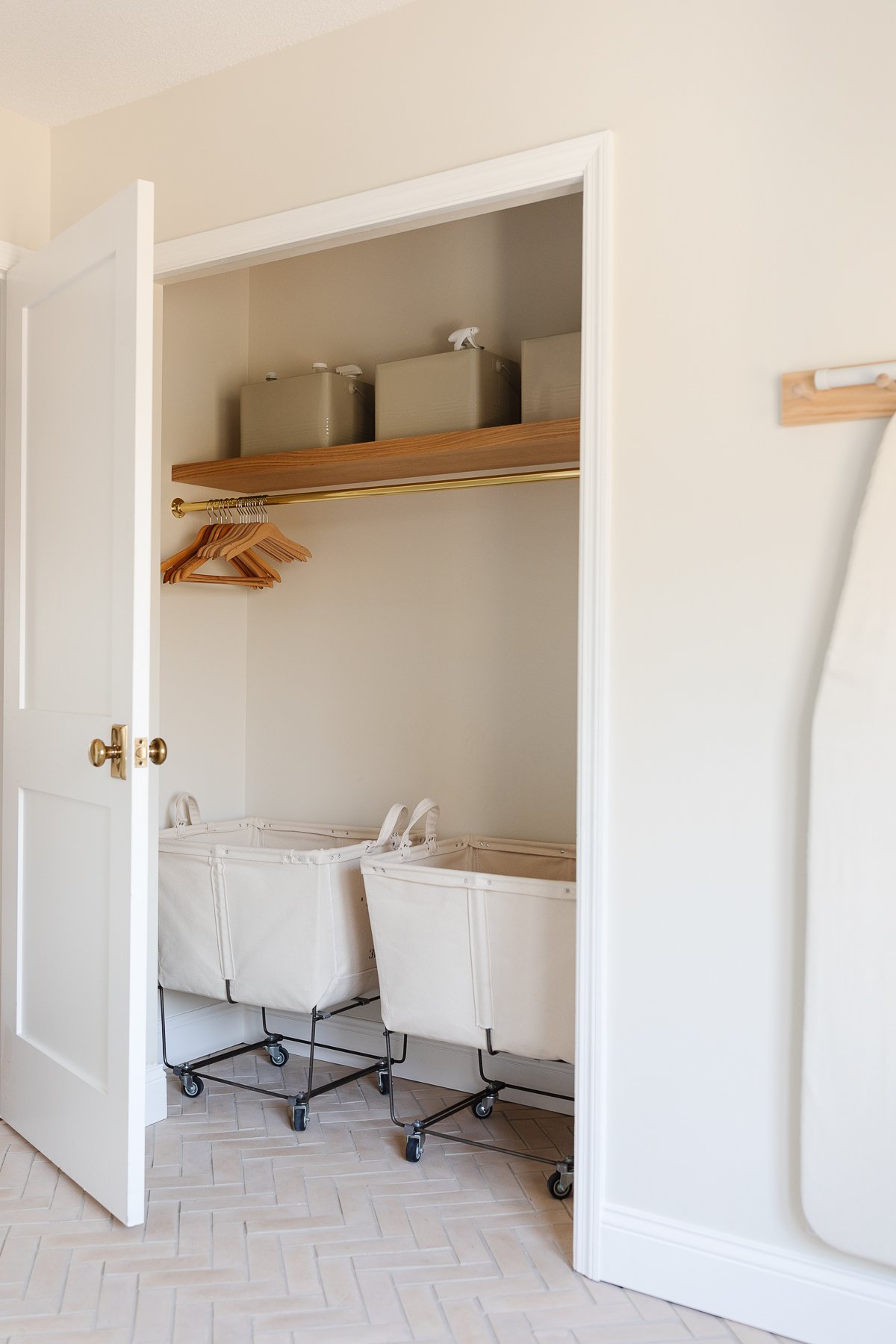 A white laundry room with shaker style doors on the washer and dryer.